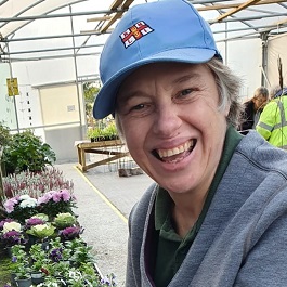 Smiling woman in a blue baseball cap