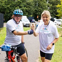 Mike handing the baton to Suzanne